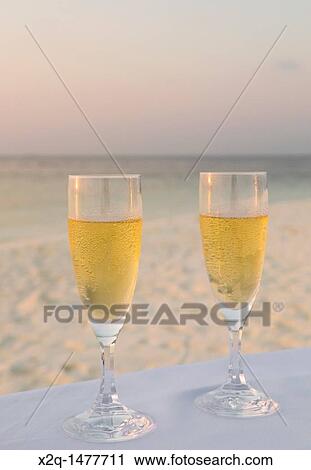 Close-up of two champagne flutes at a beach in the Maldives View Large Photo Image Stock Image - Close-up of two champagne flutes at a beach in the Maldives. Fotosearch