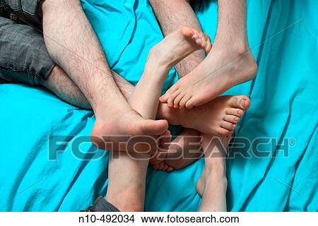 Close-up of two teen boy's and teen girl's feet playing together View Large Photo Image Picture - Close-up of two teen boy's and teen girl's feet playing together. Fotosearch
