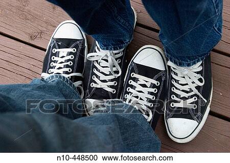 Close-up of two teen boys? feet wearing identical sneakers and standing very close to each other View Large Photo Image Stock Image - Close-up of two teen boys? feet wearing identical sneakers and standing very close to each other. Fotosearch