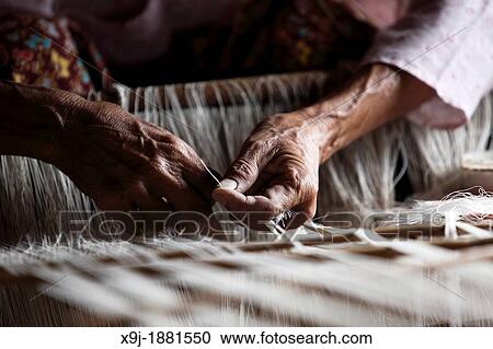 Close-up of Weaver weaving in a weaving mill, Inle Lake, Shan state, Myanmar, Burma View Large Photo Image Stock Image - Close-up of Weaver weaving in a weaving mill, Inle Lake, Shan state, Myanmar, Burma. Fotosearch