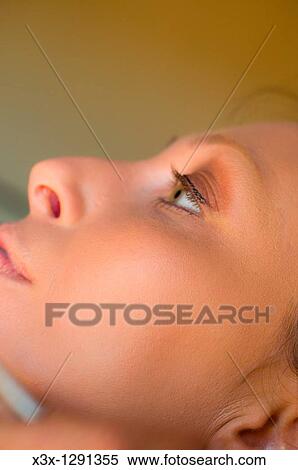 Stock Photography - Close-up of woman face, side view. Fotosearch
