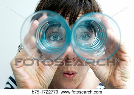 Close-up of woman looking through glasses View Large Photo Image Stock Photo - Close-up of woman looking through glasses. Fotosearch