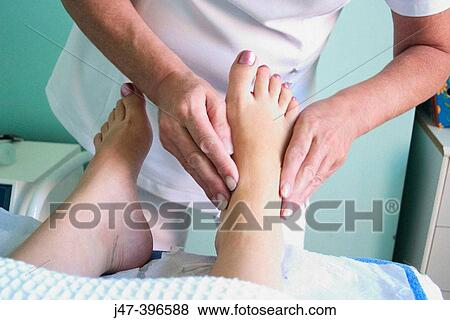 Stock Photo - Close up of womans feet, having a foot massage. Fotosearch