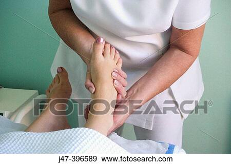 Stock Photo - Close up of womans feet, having a foot massage. Fotosearch