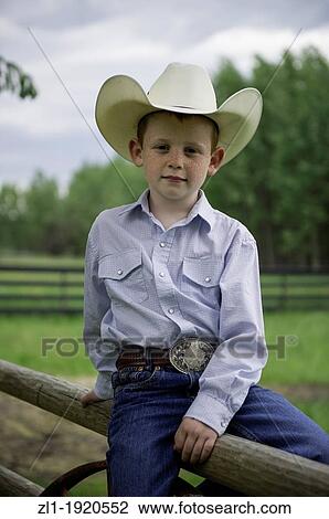 Close up of young cowboys sitting on fence. Telkwa, British Columbia View Large Photo Image Stock Image - Close up of young cowboys sitting on fence. Telkwa, British Columbia. Fotosearch