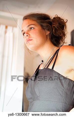 Stock Photo - close up of young woman dress shopping land looking in mirror. Fotosearch