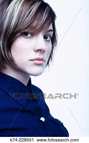 Stock Image - close up of young woman gazing at viewer. Fotosearch