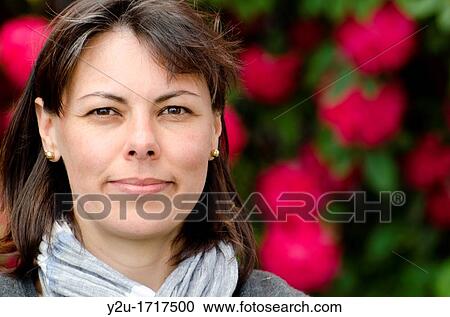 Close up on a self confident woman with flowers View Large Photo Image Stock Image - Close up on a self confident woman with flowers. Fotosearch