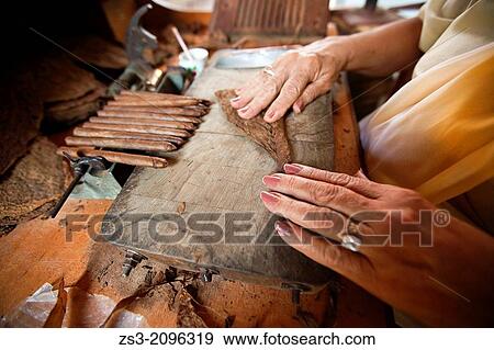 Close-Up photo of a woman preparing a cuban cigar in Casa de la Cultura, Trinidad, Sancti Sp? ritus Province, Cuba, West Antilles, Central America. View Large Photo Image Stock Photo - Close-Up photo of a woman preparing a cuban cigar in Casa de la Cultura, Trinidad, Sancti Sp? ritus Province, Cuba, West Antilles, Central America.. Fotosearch