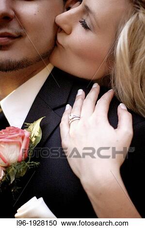 close-up photo of bride and groom stealing a moment alone on their wedding day kissing his cheek View Large Photo Image Stock Image - close-up photo of bride and groom stealing a moment alone on their wedding day kissing his cheek. Fotosearch