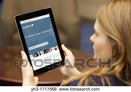 Close up picture of a young woman logging in on Twitter social networking website View Large Photo Image Stock Photo - Close up picture of a young woman logging in on Twitter social networking website. Fotosearch