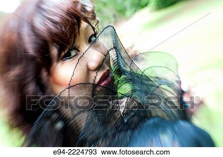 Stock Image - Close up portrait of a 38 year old Asian-American looking at the camera.. Fotosearch
