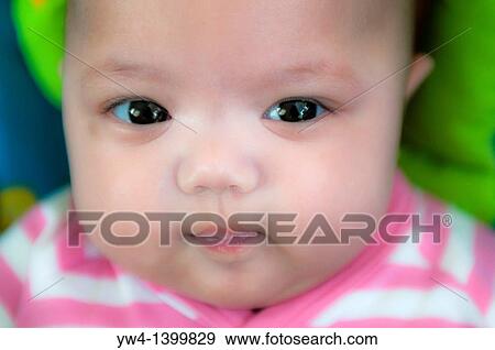 Stock Photo - Close up portrait of a baby girl. Fotosearch