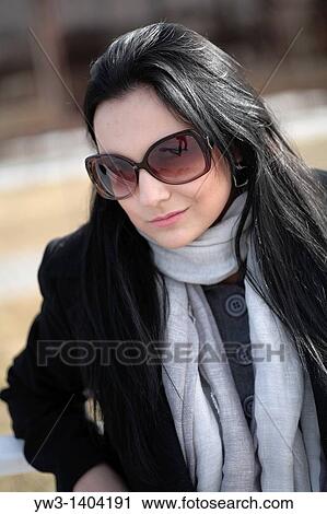 Stock Image - Close-up portrait of a beautiful 20-25 years women outdoors in the spring. Fotosearch