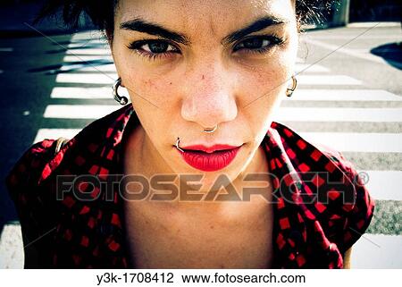 Stock Image - Close up portrait of a girl with a street background.. Fotosearch
