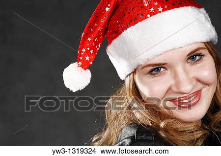Close-up portrait of a woman wearing a Christmas hat View Large Photo Image Picture - Close-up portrait of a woman wearing a Christmas hat. Fotosearch