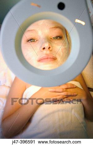 Close up shot of woman having a facial through a manifying mirror, at the beauty salon View Large Photo Image Stock Image - Close up shot of woman having a facial through a manifying mirror, at the beauty salon. Fotosearch