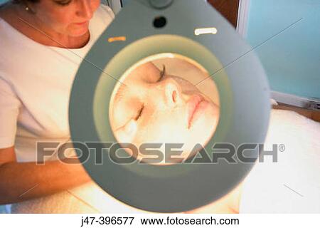 close up shot of woman having a facial through a manifying mirror, at the beauty salon View Large Photo Image Stock Photo - close up shot of woman having a facial through a manifying mirror, at the beauty salon. Fotosearch