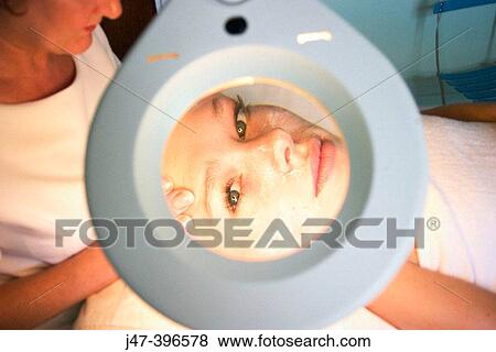close up shot of woman having a facial through a manifying mirror, at the beauty salon View Large Photo Image Stock Photo - close up shot of woman having a facial through a manifying mirror, at the beauty salon. Fotosearch