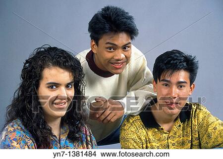 Picture - close up studio portrait of three happy teenagers from varying ethnic backgounds. Fotosearch
