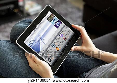 Close up view of a woman checking stock market with Bloomberg finance application on her iPad View Large Photo Image Picture - Close up view of a woman checking stock market with Bloomberg finance application on her iPad. Fotosearch
