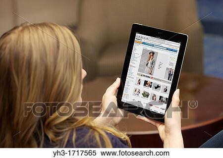 Close up view of a young Caucasian woman browsing Amazon online shopping store on an iPad 2 with wireless internet connection View Large Photo Image Stock Photography - Close up view of a young Caucasian woman browsing Amazon online shopping store on an iPad 2 with wireless internet connection. Fotosearch