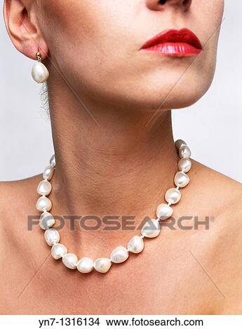 close up view of models neck with string of pearls with earrings View Large Photo Image Picture - close up view of models neck with string of pearls with earrings. Fotosearch