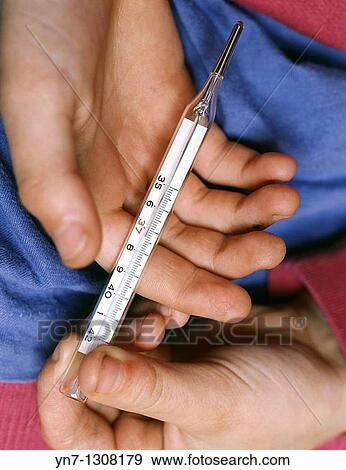close view of a sick childs hands holding a thermometer View Large Photo Image Stock Photo - close view of a sick childs hands holding a thermometer. Fotosearch