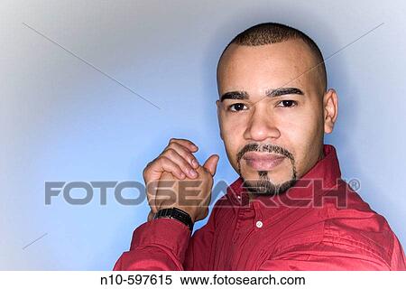 Close_up of a young Hispanic man, with a mustache and beard, posing View Large Photo Image Stock Photography - Close_up of a young Hispanic man, with a mustache and beard, posing. Fotosearch