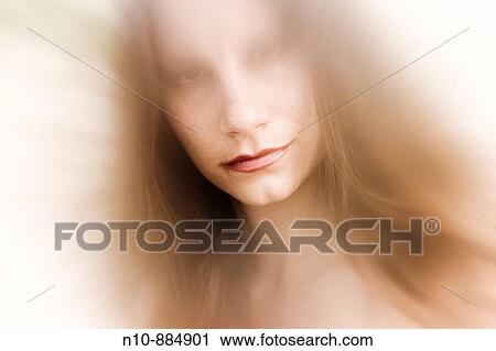 Stock Image - Close_up of a young woman at the beach. Model Released.. Fotosearch