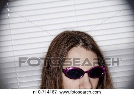 Close_up of a young woman wearing sunglasses. View Large Photo Image Stock Photo - Close_up of a young woman wearing sunglasses.. Fotosearch
