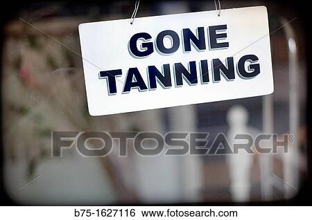 Stock Photograph - closed sign in a business, gone tanning. Fotosearch