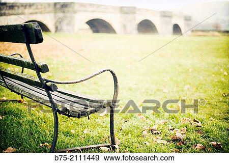 Stock Photo - Closeup of a bank with the River Wharfe and the bridge in the background Burnsal, Yorkshire Dales, England, UK, Europe.. Fotosearch