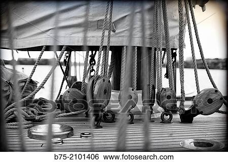 Closeup of a classic sailboat deck with pulleys, ropes, and sails at the Port Mahon, Menorca, Balearic Islands, Spain. View Large Photo Image Stock Photograph - Closeup of a classic sailboat deck with pulleys, ropes, and sails at the Port Mahon, Menorca, Balearic Islands, Spain.. Fotosearch