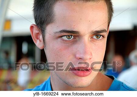Closeup of a happy boy speaking and sitting at a table View Large Photo Image Picture - Closeup of a happy boy speaking and sitting at a table. Fotosearch