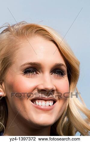 Stock Image - Closeup of a young woman outdoors. Fotosearch