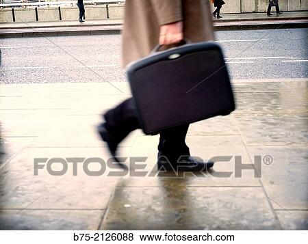 Closeup of an unrecognizable executive with portfolio walking down the street, London, England, UK, Europe. View Large Photo Image Stock Photo - Closeup of an unrecognizable executive with portfolio walking down the street, London, England, UK, Europe.. Fotosearch
