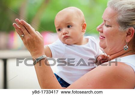 Closeup of grandmother dancing with her baby grandchild View Large Photo Image Stock Photo - Closeup of grandmother dancing with her baby grandchild. Fotosearch