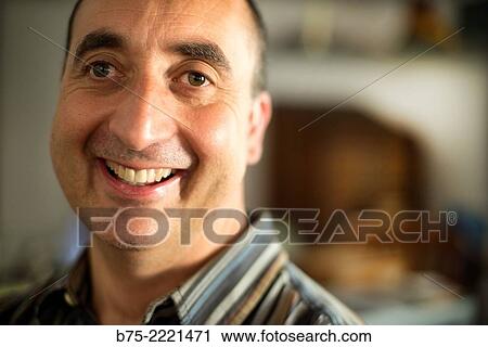 Stock Image - Closeup of the face of a happy middle aged man, with a smile on his face. Fotosearch