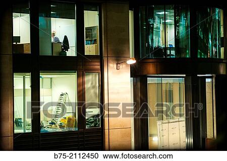 Closeup of the windows of an office building with an unrecognizable man in his office. City of London, England, UK, Europe. View Large Photo Image Stock Image - Closeup of the windows of an office building with an unrecognizable man in his office. City of London, England, UK, Europe.. Fotosearch
