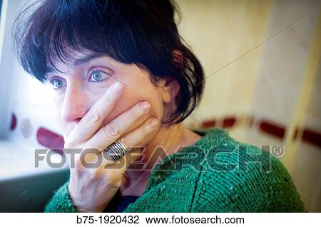 Stock Image - Closeup of woman with expression of concern. Fotosearch