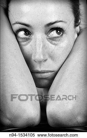 Closeup of young woman, face resting on her arms and looking sideways. View Large Photo Image Stock Photography - Closeup of young woman, face resting on her arms and looking sideways.. Fotosearch