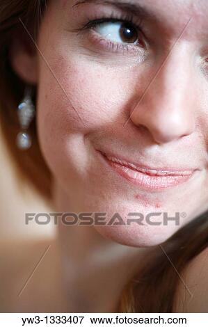 closeup part of face of pretty girl against light wall blank expression View Large Photo Image Stock Photo - closeup part of face of pretty girl against light wall blank expression. Fotosearch