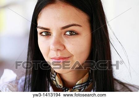 Closeup portrait of a beautiful 20-25 years happy woman in blur background outdoors View Large Photo Image Picture - Closeup portrait of a beautiful 20-25 years happy woman in blur background outdoors. Fotosearch