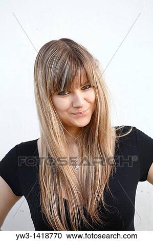 Stock Image - Closeup portrait of a beautiful 20-25 years woman outdoors with funny face. Fotosearch