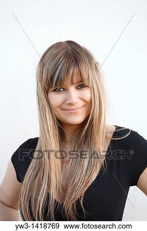 Stock Photo - Closeup portrait of a beautiful 20-25 years woman outdoors with funny face. Fotosearch