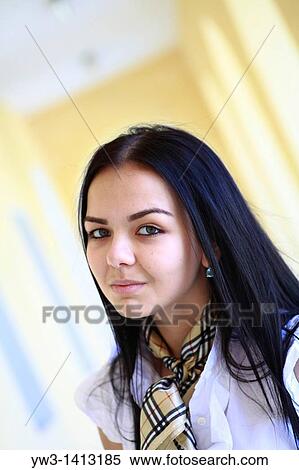 Stock Photography - Closeup portrait of a beautiful 20-25 years happy woman in blur background outdoors. Fotosearch