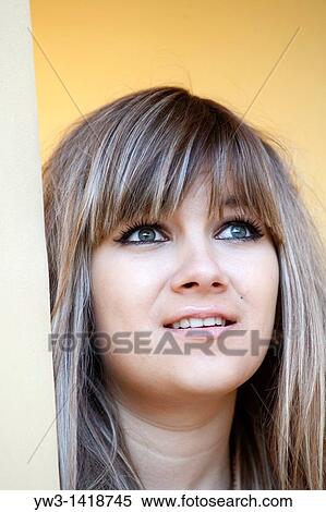 Stock Photography - Closeup portrait of a beautiful 20-25 years happy woman outdoors. Fotosearch