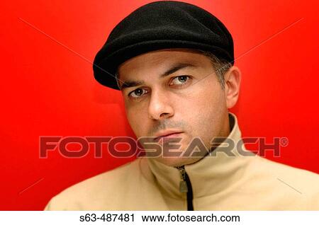 Closeup portrait of a man in his 30s wearing a black hat against red background View Large Photo Image Stock Image - Closeup portrait of a man in his 30s wearing a black hat against red background. Fotosearch