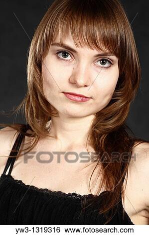 Stock Photograph - closeup portrait of a young adult woman blank expression. Fotosearch